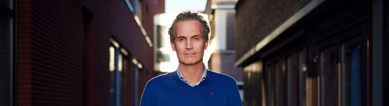 man with blue sweater outside
